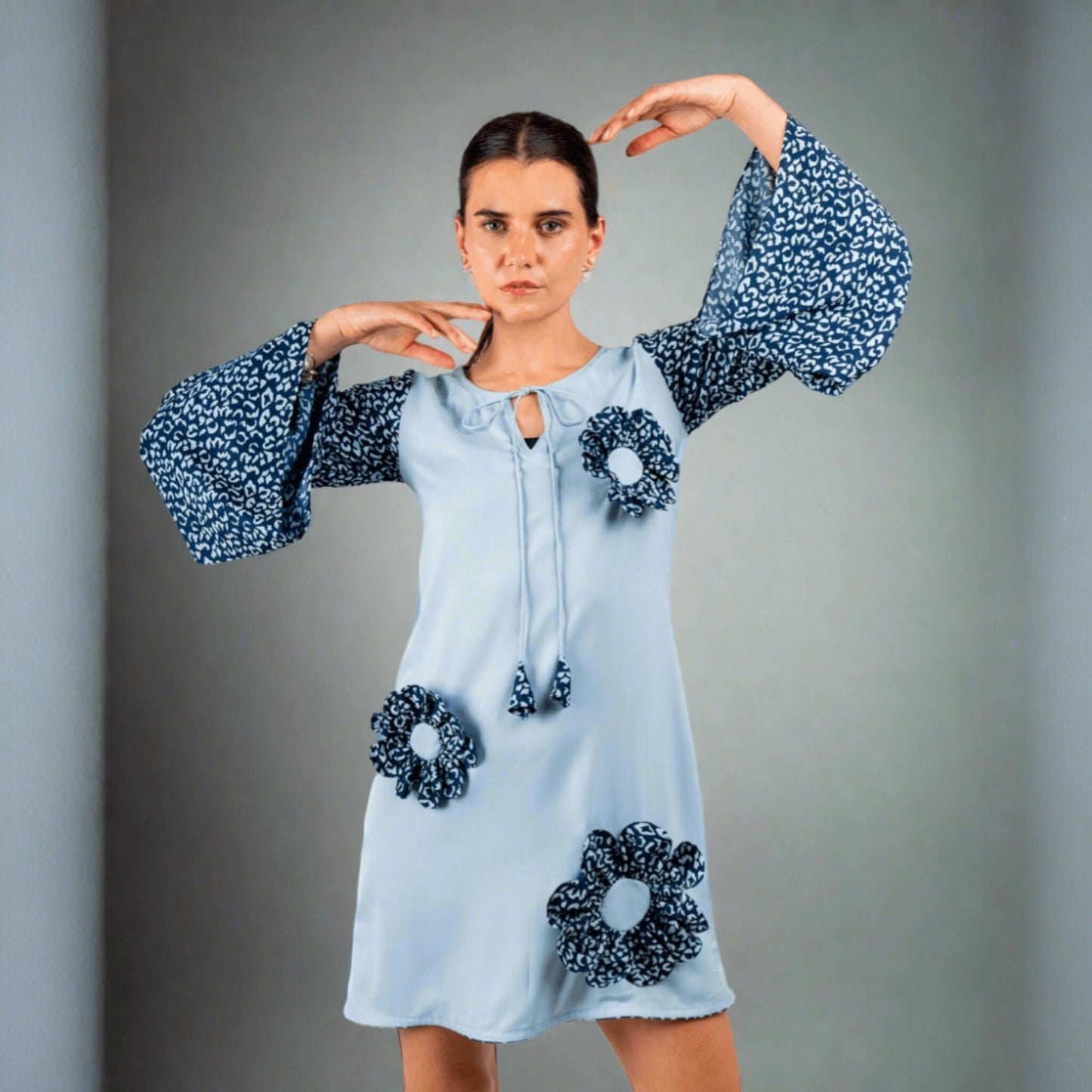 Blue double georgette tunic dress with bell sleeves, playful patchwork details, round neck string tie, modeled front view.