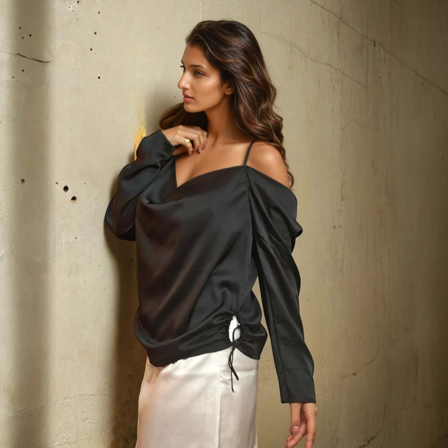 Model showcasing the black satin cowl top with off-shoulder sleeves from House Of Majisha, styled for a casual outing