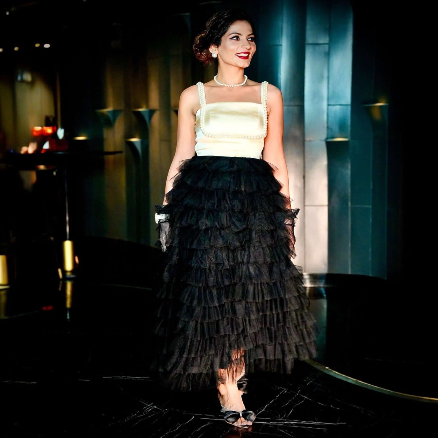 An elegant beige and black Vintage Dress with ruffle skirt, pearl strap, and under bust decoration from House Of Majisha, perfect for parties and special occasions, ensuring you steal the spotlight with its luxurious materials and charming design.