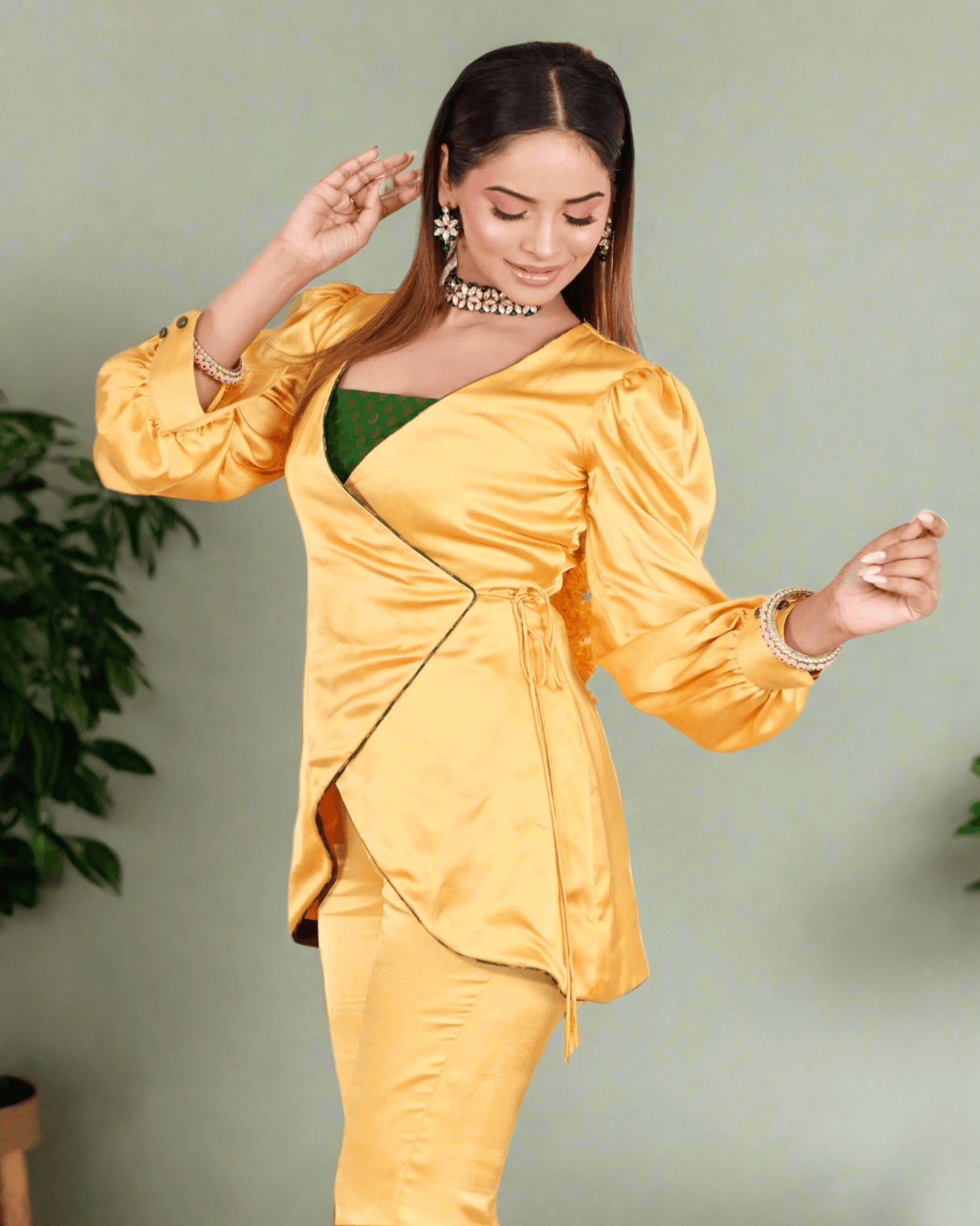 Yellow Armani Satin Wrap Coord Set - Elegant fusion wear for women featuring a V-neck wrap top with puffy sleeves and tailored waist tie, paired with fitted satin pants and a green brocade tube underneath. Perfect for festive occasions or chic parties.