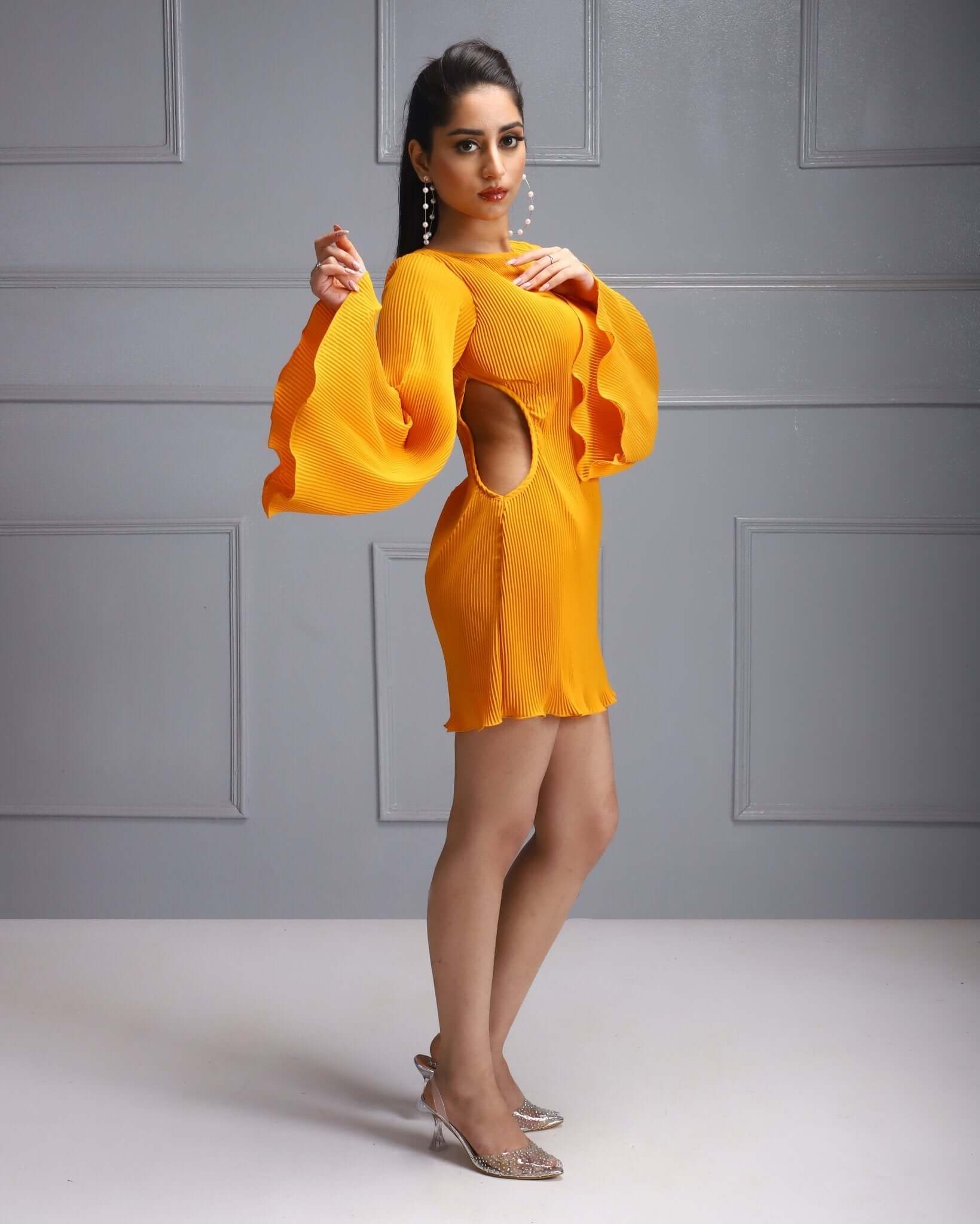This vibrant yellow dress features dramatic bell sleeves and a playful side cut-out, perfect for a bold and stylish look.