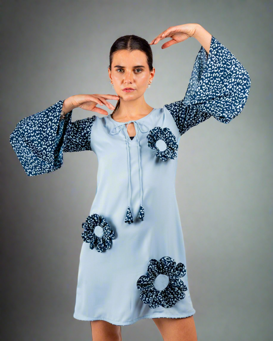 Blue double georgette tunic dress with bell sleeves, playful patchwork details, round neck string tie, modeled front view.