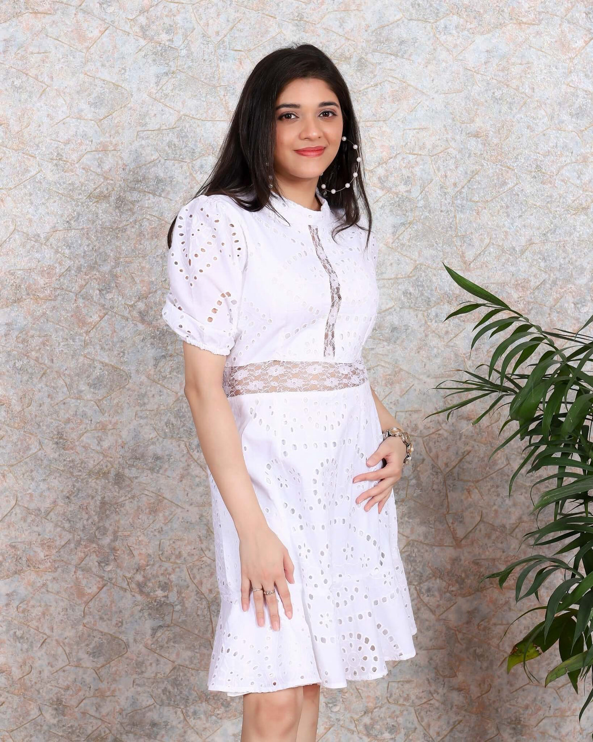 Woman in white Hakoba dress from House Of Majisha, showcasing cutwork artistry and lacy accents, perfect for western party wear.