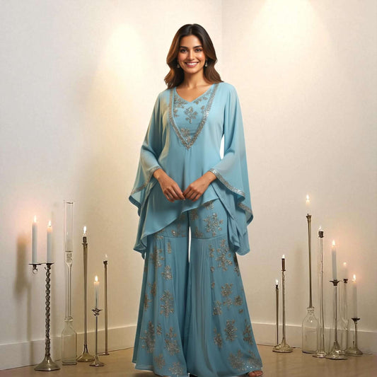 Indian model wearing a blue Chanderi georgette embroidered kurta with flared pants, styled by House of Majisha, surrounded by candles.