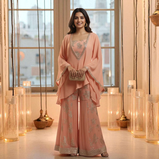 Model wearing the Blush Radiance Chanderi Georgette Set in soft peach pink with silver embroidery and flared pants, styled by House of Majisha in a lantern-lit setting.