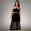 Model showcasing the Boho Beach Set featuring a black crochet net top with a criss-cross neckline and a sheer skirt, perfect for beach outings from House of Majisha.