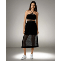 Model showcasing the Boho Beach Set featuring a black crochet net top with a criss-cross neckline and a sheer skirt, perfect for beach outings from House of Majisha.