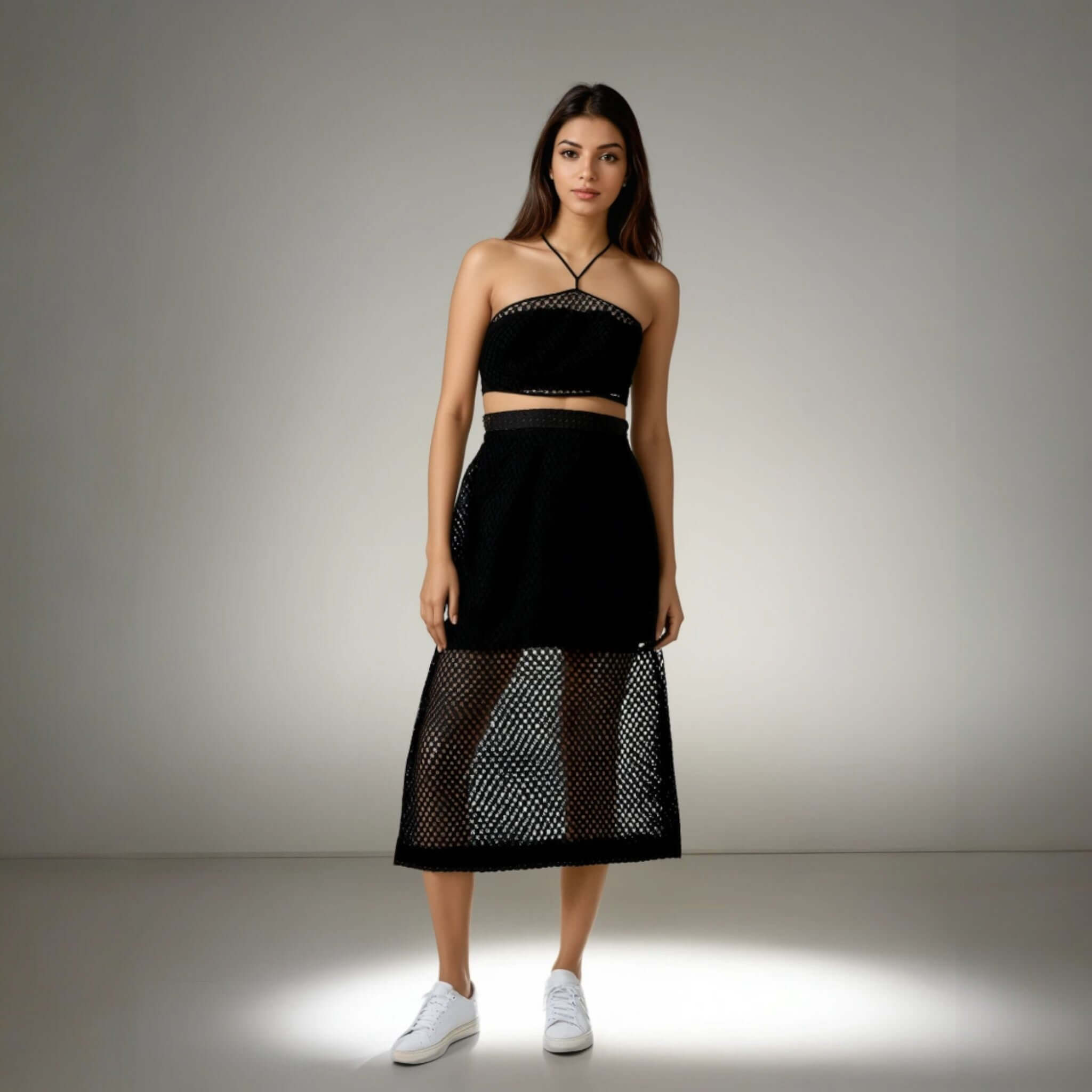 Model showcasing the Boho Beach Set featuring a black crochet net top with a criss-cross neckline and a sheer skirt, perfect for beach outings from House of Majisha.