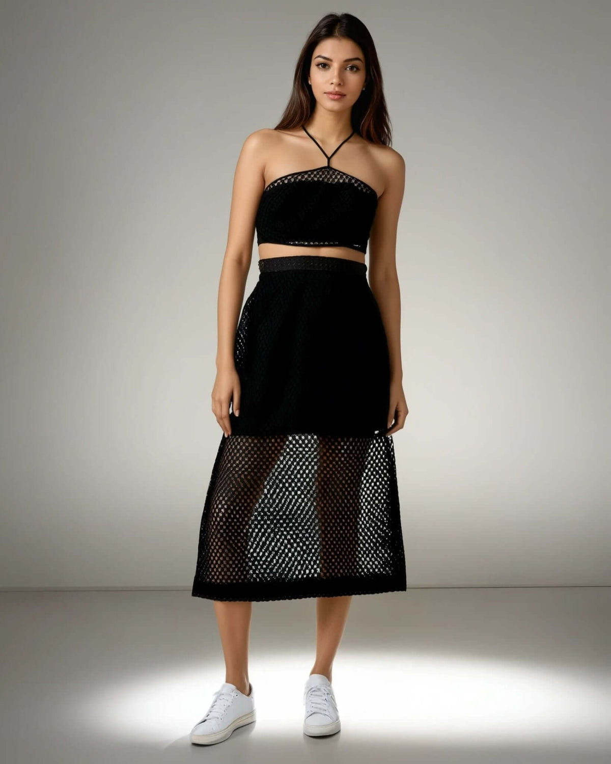 Model showcasing the Boho Beach Set featuring a black crochet net top with a criss-cross neckline and a sheer skirt, perfect for beach outings from House of Majisha.