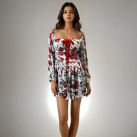 Featuring a sweetheart neckline and bow detailing, perfect for casual outings and parties, Model showcasing the Charming Print Dress in red and white floral design from House Of Majisha.