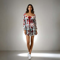 Featuring a sweetheart neckline and bow detailing, perfect for casual outings and parties, Model showcasing the Charming Print Dress in red and white floral design from House Of Majisha.