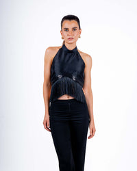 Model wearing black halter top with fringe details and backless design, perfect for parties and nights out.