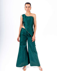 Woman wearing emerald green coord set with off-shoulder asymmetrical top and flared palazzo pants, perfect for evening parties.