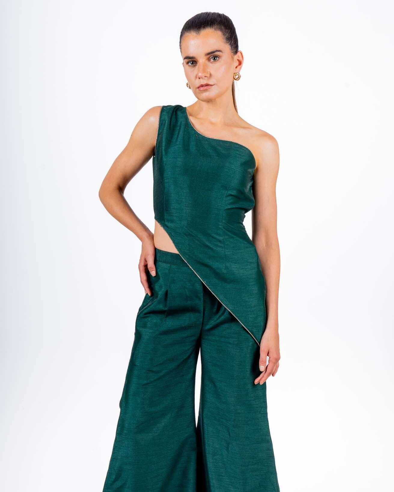 Emerald green coord set with off-shoulder asymmetrical top and flared palazzo pants, perfect for evening parties and clubwear sophistication