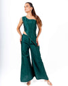 Woman wearing emerald green coord set with an off-shoulder asymmetrical top and flared palazzo pants, perfect for clubwear and evening parties