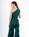 Woman wearing emerald green off-shoulder coord set with asymmetrical top and flared palazzo pants, perfect for evening parties and clubwear.