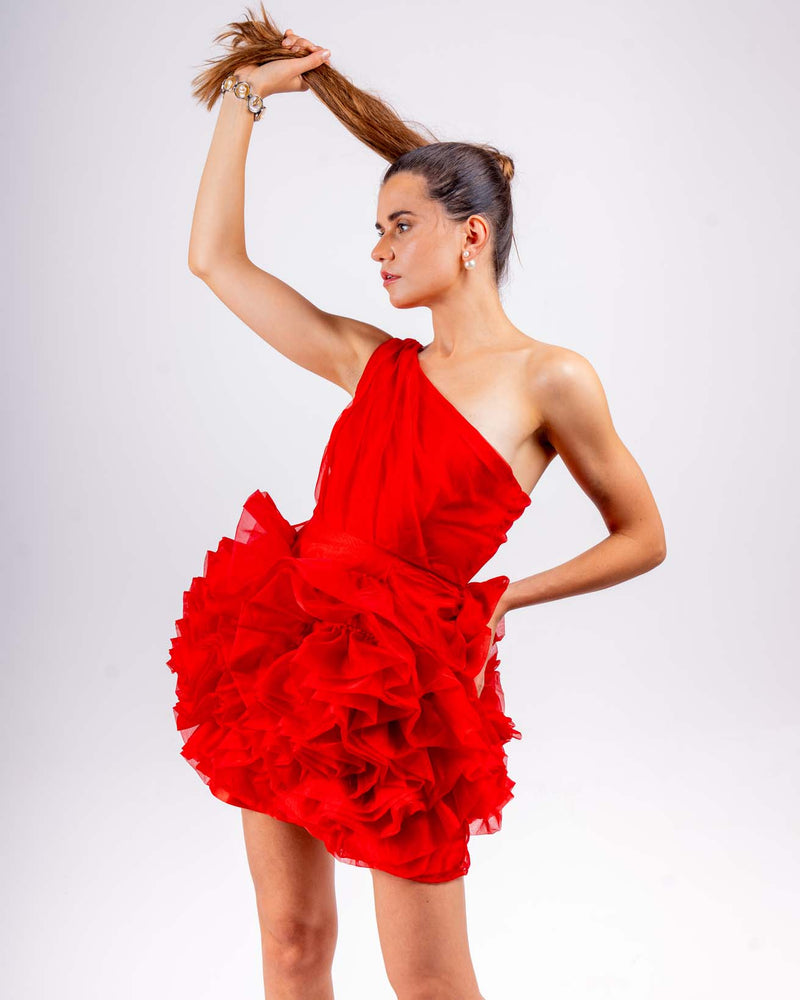 Woman wearing vibrant red one-shoulder ruffled doll dress made of organza with dramatic layers, ideal for party, club wear, and birthdays.