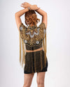 This elegant cape features intricate gold and silver embroidery with long fringe detailing, perfect for adding a regal touch to any outfit. A stunning embroidered cape with gold and silver accents, complete with dramatic fringe for a sophisticated, standout look.