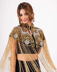 This elegant cape features intricate gold and silver embroidery with long fringe detailing, perfect for adding a regal touch to any outfit