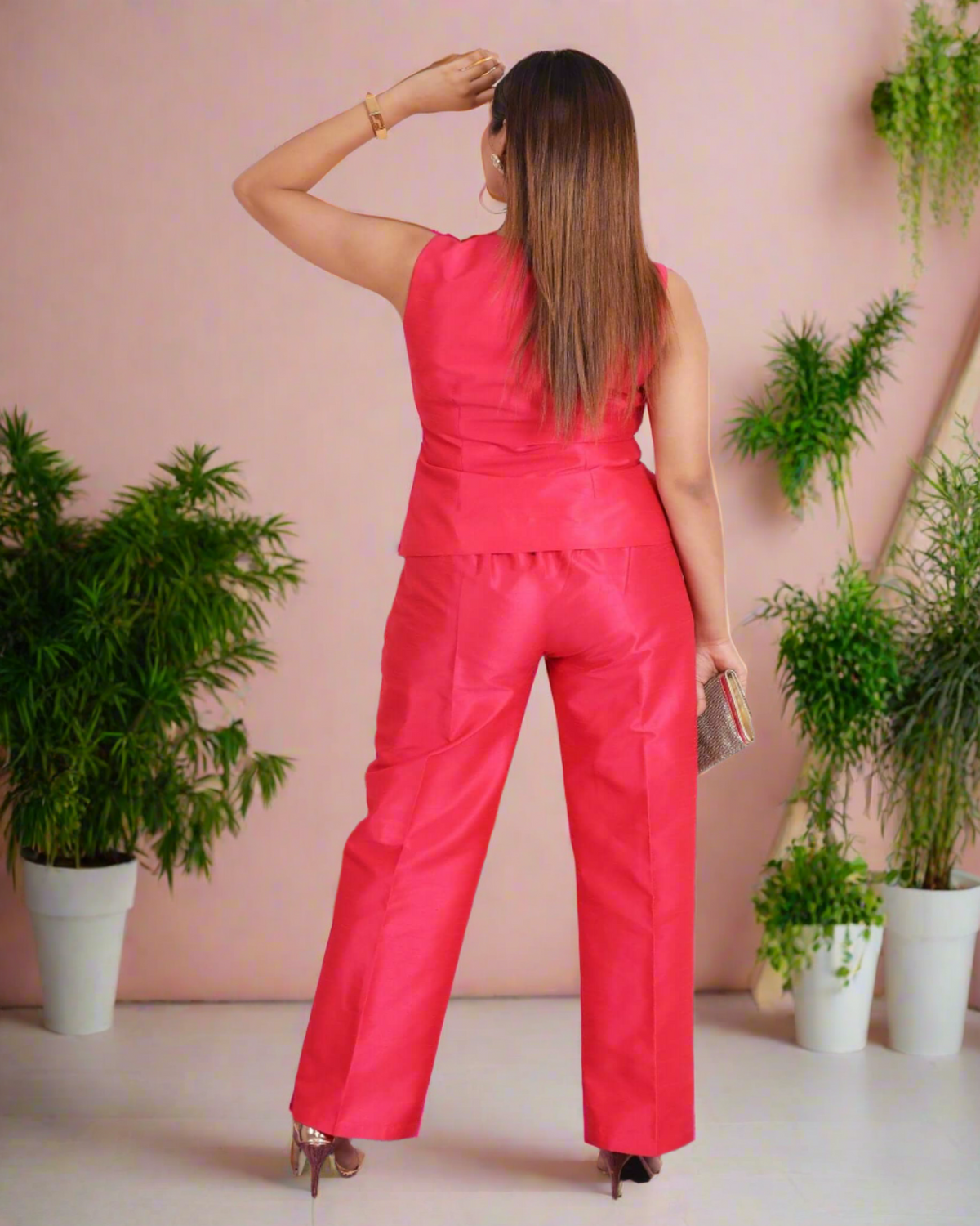 Stylish Fuchsia Pink Coord Set for Women: Sleeveless vest with V-neckline and golden buttons paired with high-waisted trousers in lustrous fabric, exuding sophistication and modern chic.