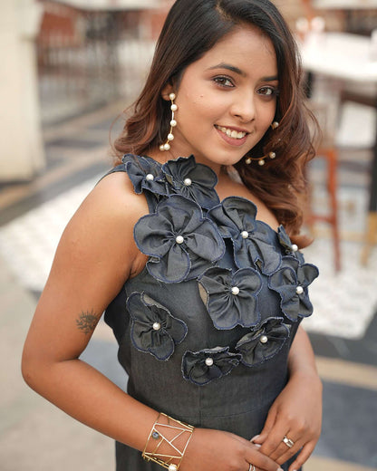 Woman wearing the Chic Denim Delight one-shoulder dress with handmade flower patches, perfect for brunches, casual dates, and evening parties.