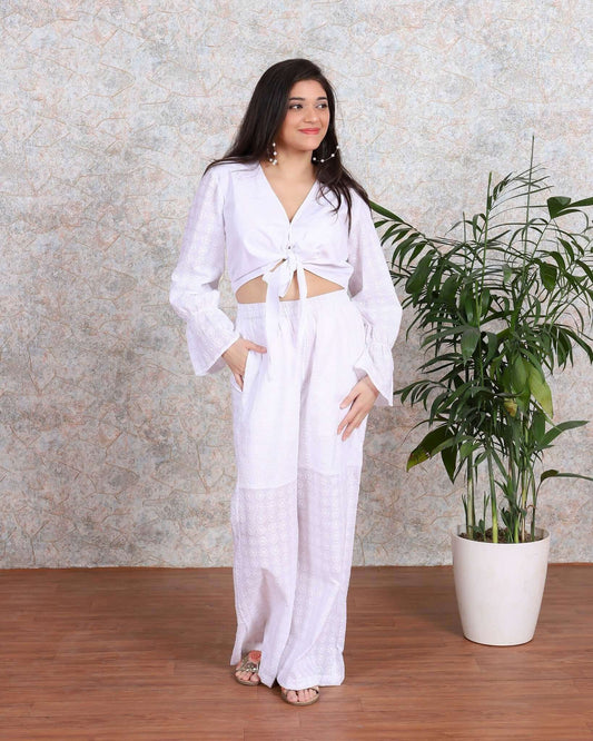 White coord set with chikkankari embroidery, perfect for summer beach wear, featuring a cropped top and wide-legged pants.
