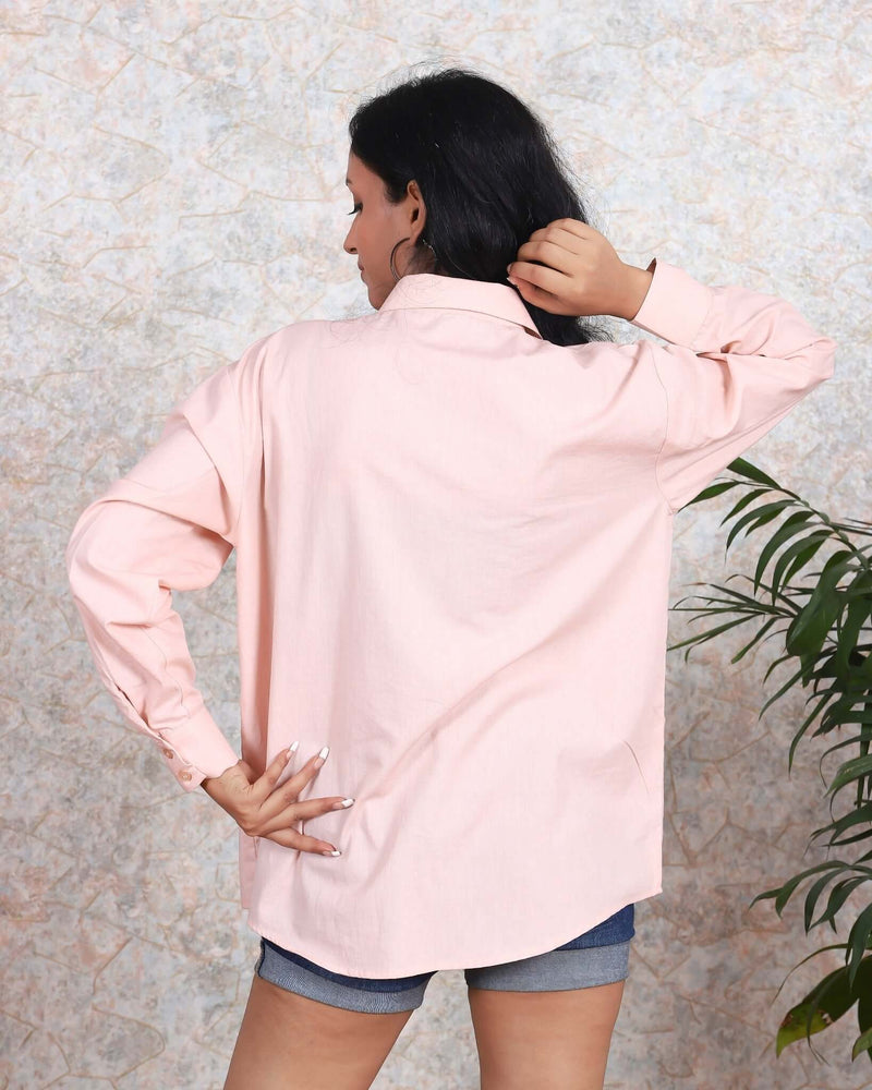 Woman wearing a House Of Majisha pink cotton shirt with whimsical white butterflies, showcasing the back design, perfect for trendy casual summer fashion.