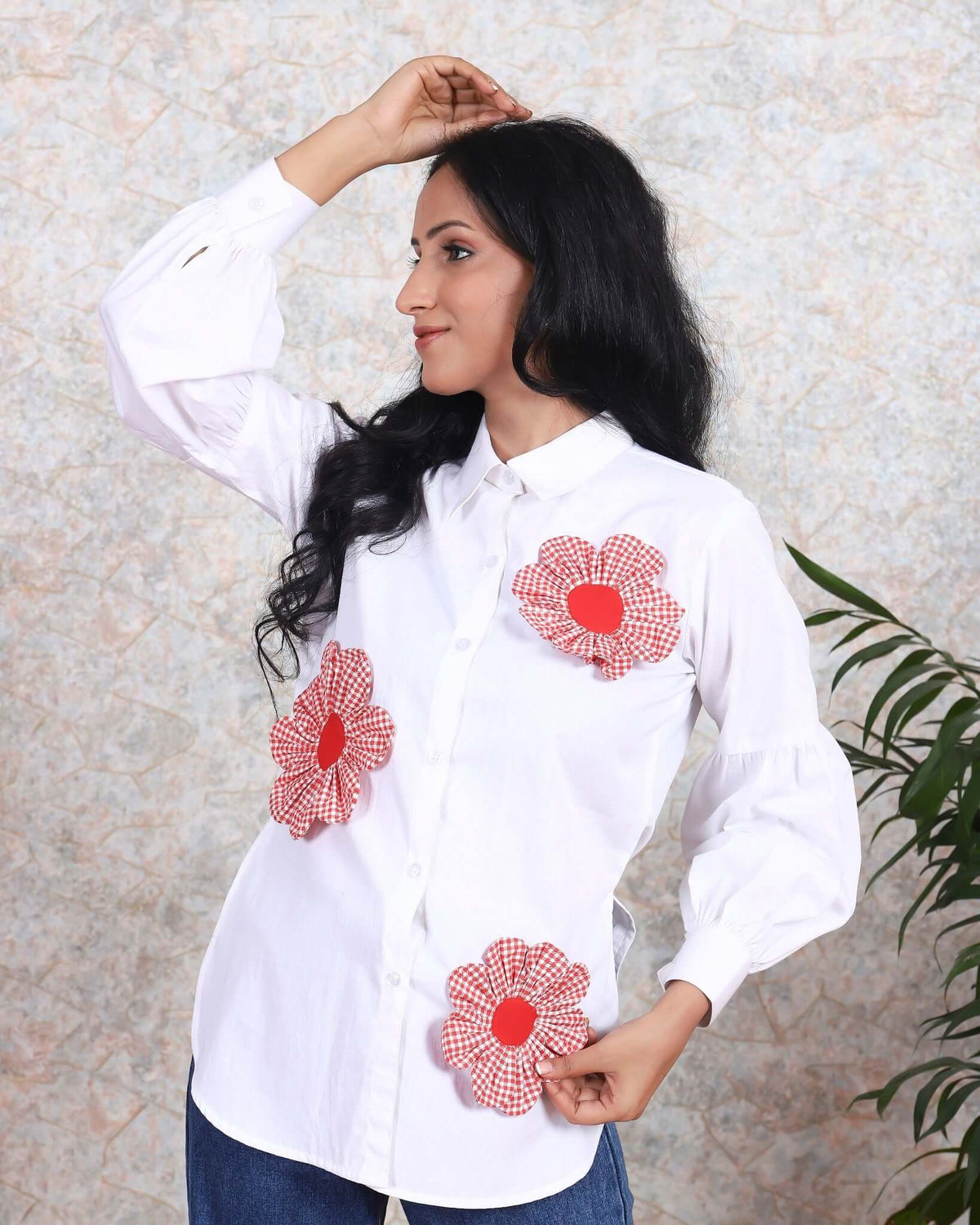 Woman modeling trendy white cotton shirt with red floral appliqués from House Of Majisha, perfect for casual summer fashion.