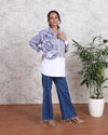 Woman wearing a trendy stripe cotton shirt with dramatic ruffled sleeves, paired with blue jeans, showcasing summer fashion from House Of Majisha.