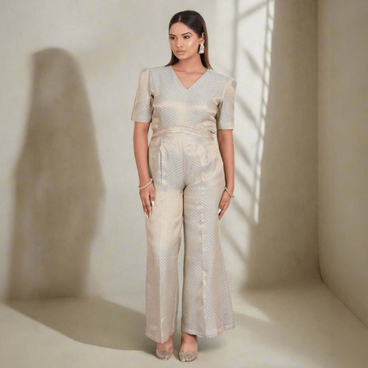 Exquisite brocade jumpsuit in soft gold with chic Indo-Western style, V-neckline, and short sleeves - perfect for festive occasions and parties.