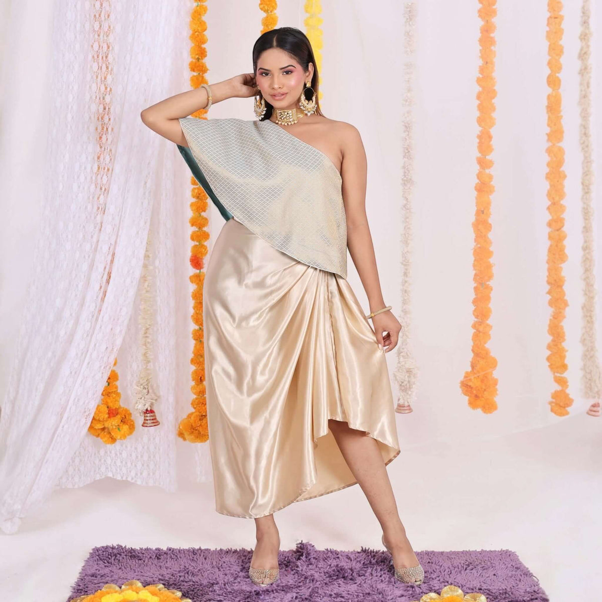 Brocade Top with Satin Dhoti: Elegant grey brocade one-shoulder top paired with golden satin dhoti for a modern Indo-Western look. Perfect for festive occasions and weddings.