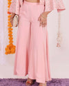 Stylish Peach Flared Pants for Women - Lightweight georgette fabric in peach color, wide-leg design, high-waisted, perfect for festive and casual occasions.