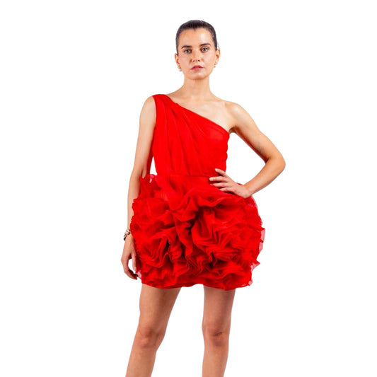 Woman wearing vibrant red one-shoulder ruffled doll dress made of organza with dramatic layers and a playful silhouette.