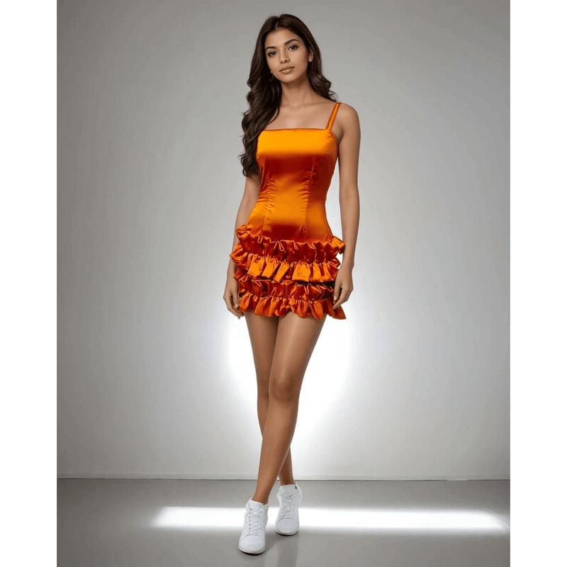 Model showcasing the Ruffle Radiance Dress in vibrant orange satin with ruffle detailing at the bottom from House Of Majisha, ideal for parties and brunch outings.