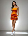 Model showcasing the Ruffle Radiance Dress in vibrant orange satin with ruffle detailing at the bottom from House Of Majisha, ideal for parties and brunch outings.