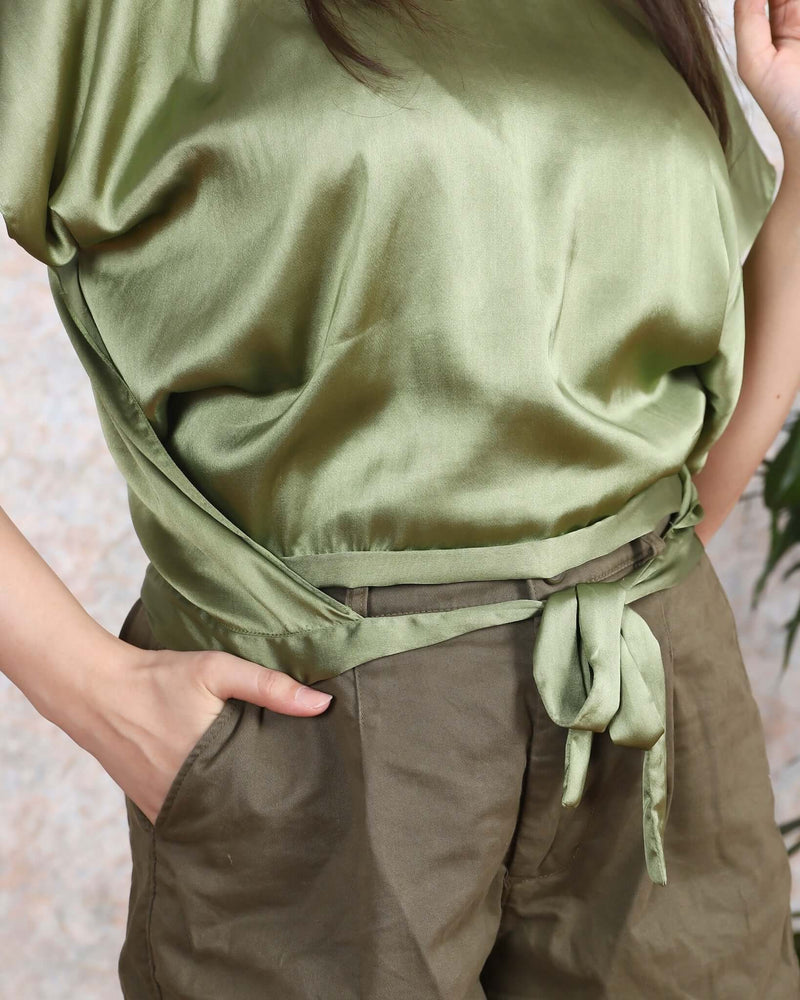 Woman wearing an olive satin cover-up top with tie-front detail from House Of Majisha. Perfect for women-party wear or western dresses.