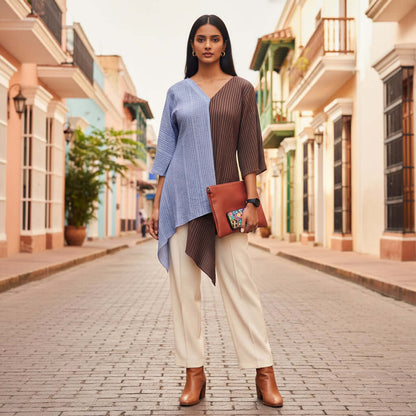 Woman walking down a sunlit street wearing a blue and brown Shoreline Split Tunic by House Of Majisha.