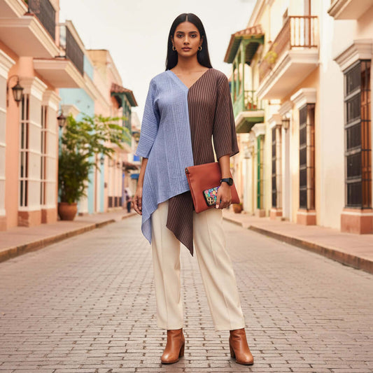 Woman walking down a sunlit street wearing a blue and brown Shoreline Split Tunic by House Of Majisha.