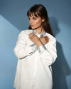 White Satin Shirt with Silver Sequin Collar and Cuffs from House Of Majisha, A stylish white satin button-down shirt featuring a shimmering silver sequin-embellished collar and cuffs, adding a touch of elegance.