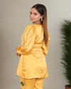 Yellow Armani Satin Wrap Coord Set for women featuring a stylish wrap top with V-neckline, puffy sleeves, and tie-up side detail paired with fitted satin pants and a green brocade tube underneath for a festive and chic look.