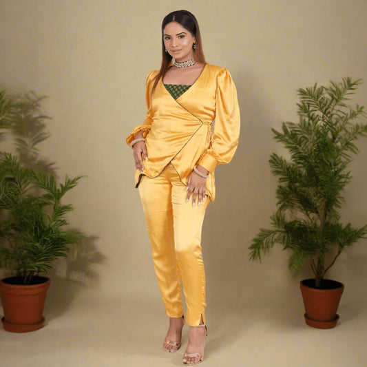 Yellow Armani Satin Wrap Coord Set - Elegant fusion wear for women featuring a V-neck wrap top with puffy sleeves and tailored waist tie, paired with fitted satin pants and a green brocade tube underneath. Perfect for festive occasions or chic parties.