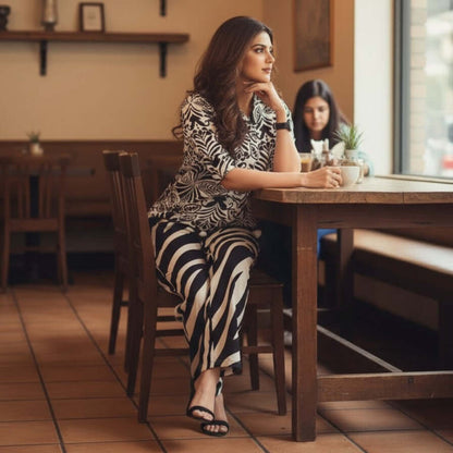 Woman wearing Black Ivory Botanical Stripe Co Ord Set top with striped pants co ord set by House of Majisha.