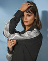 Model wearing a chic black shirt from House of Majisha, showcasing a trendy button-up design in a stylish indoor setting.