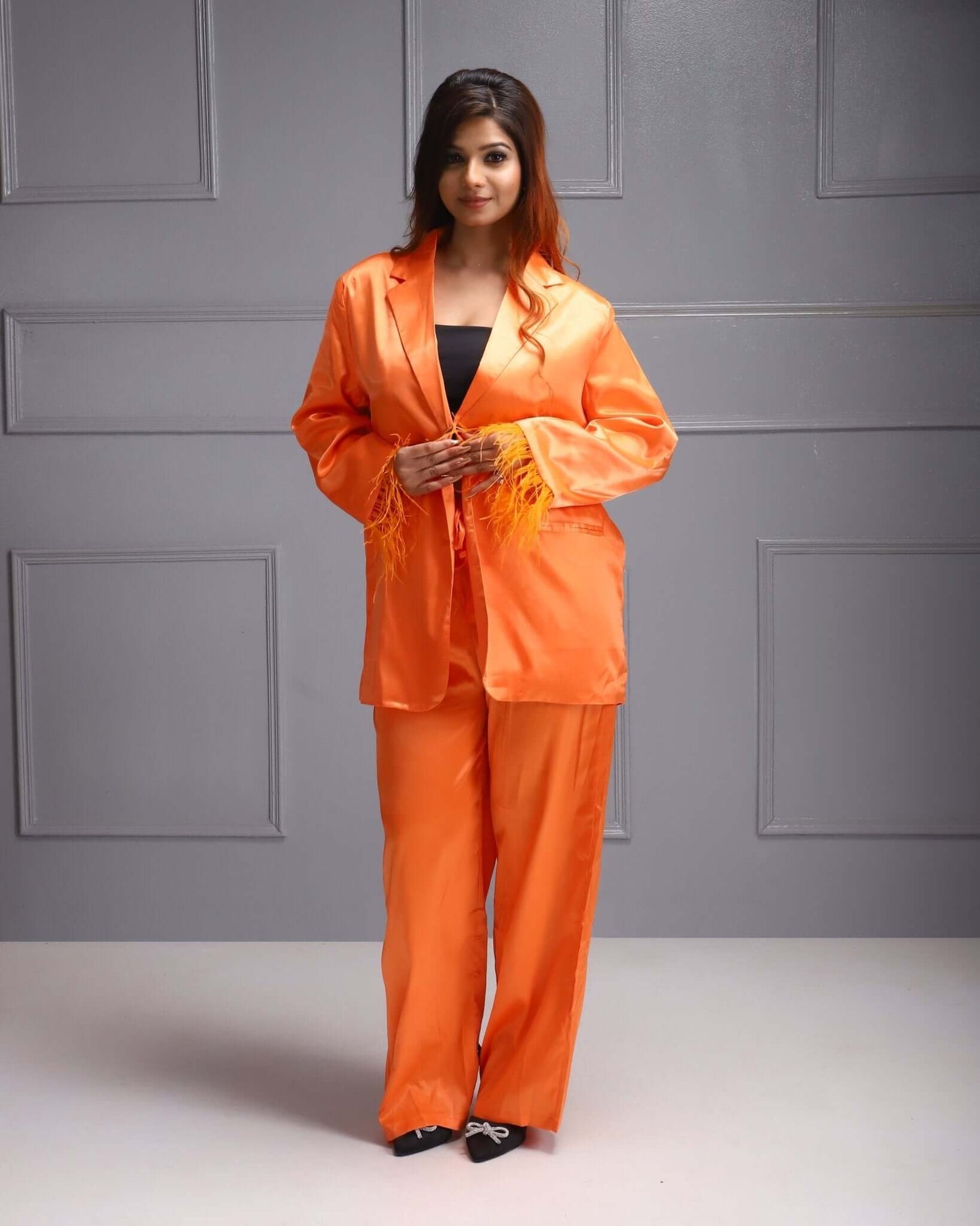 Sunset Chic Orange Coord Set: Women's trendy blazer and trousers in vibrant orange for a bold office statement.