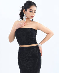 "Black sequined co-ord set featuring a strapless crop top and matching mini skirt, adorned with shimmering sequins for a glamorous evening look."