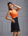 glamorous black skirt with fringe detail, chic halter necklines for women, sophisticated women's outfit inspiration,