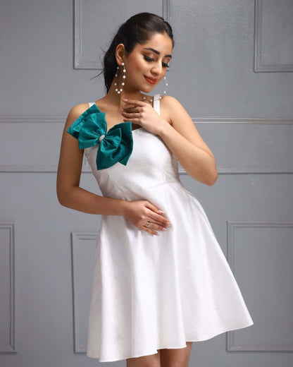 White Party Dress with a Teal Bow Accent, perfect for summer events and garden parties.